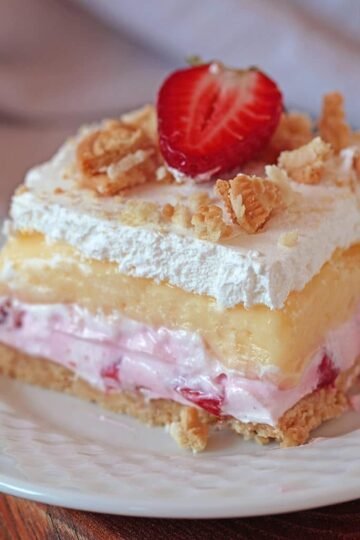 No Bake Strawberry Lush - is a layered dessert with golden Oreo crust and creamy layers of strawberry cheesecake and vanilla pudding, topped with whipped cream, crushed golden Oreos and strawberries. Its taste is just divine.