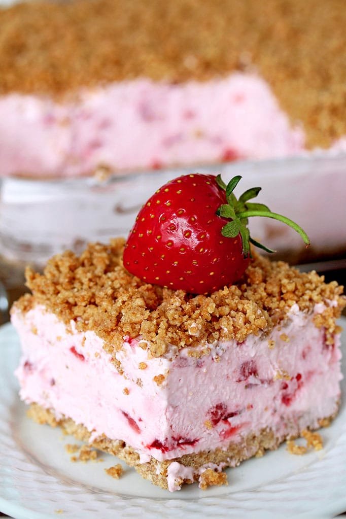 Easy Frozen Strawberry Dessert a perfect spring and summer dessert for all strawberry fans. This refreshing, creamy, frozen dessert made with fresh strawberries and a crunchy graham cracker layer, topped with graham cracker crumbs is very quick and easy to prepare.