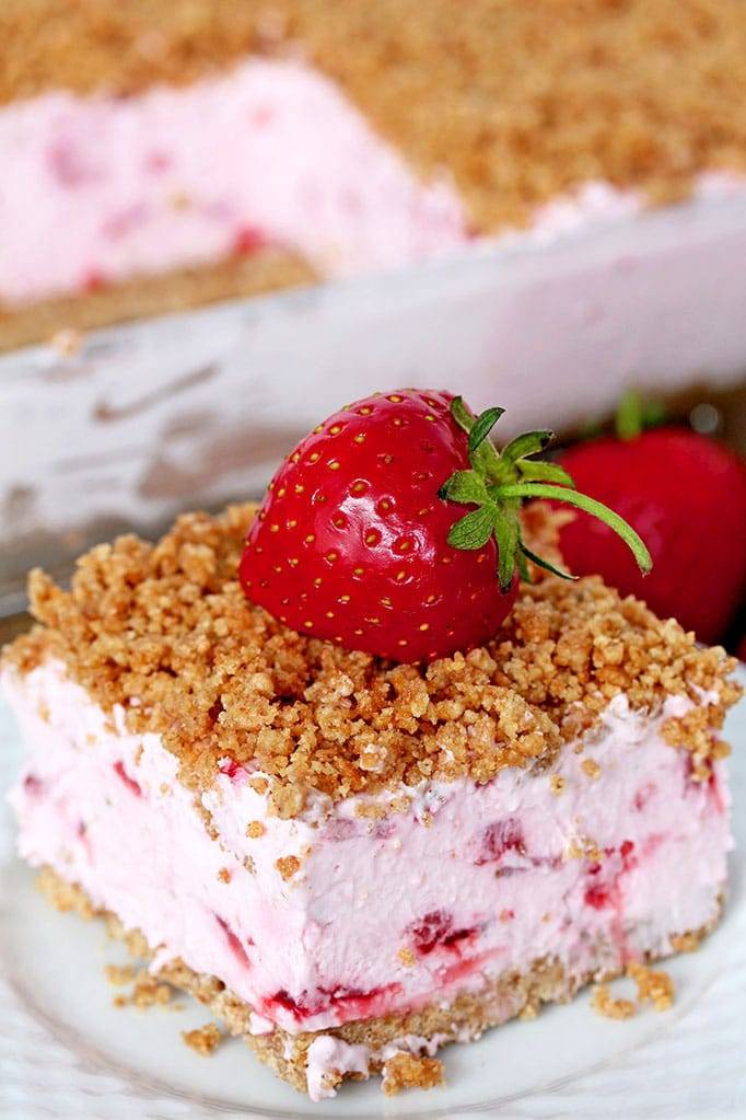 Easy Frozen Strawberry Dessert a perfect spring and summer dessert for all strawberry fans. This refreshing, creamy, frozen dessert made with fresh strawberries and a crunchy graham cracker layer, topped with graham cracker crumbs is very quick and easy to prepare.