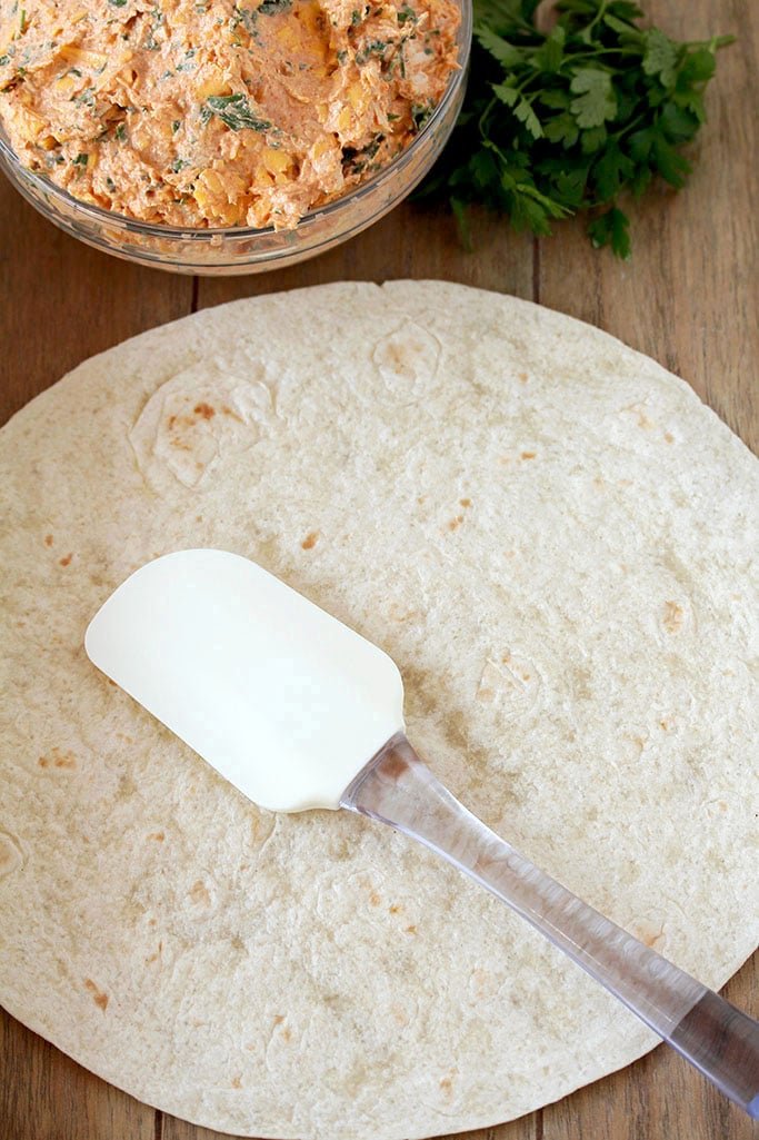 Taco Tortilla Roll Ups this quick and easy party appetizer filled with cream cheese, sour cream, chicken, cheddar cheese, taco seasoning, taco sauce and parsley is perfect for every holiday or a party.
