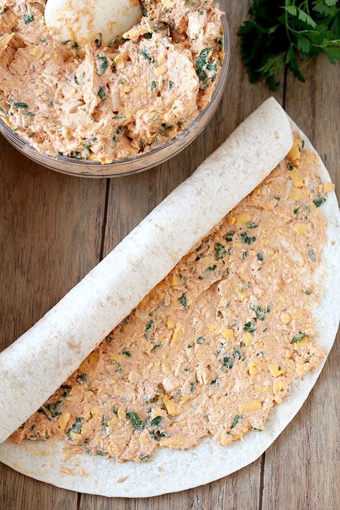 Taco Tortilla Roll Ups this quick and easy party appetizer filled with cream cheese, sour cream, chicken, cheddar cheese, taco seasoning, taco sauce and parsley is perfect for every holiday or a party.
