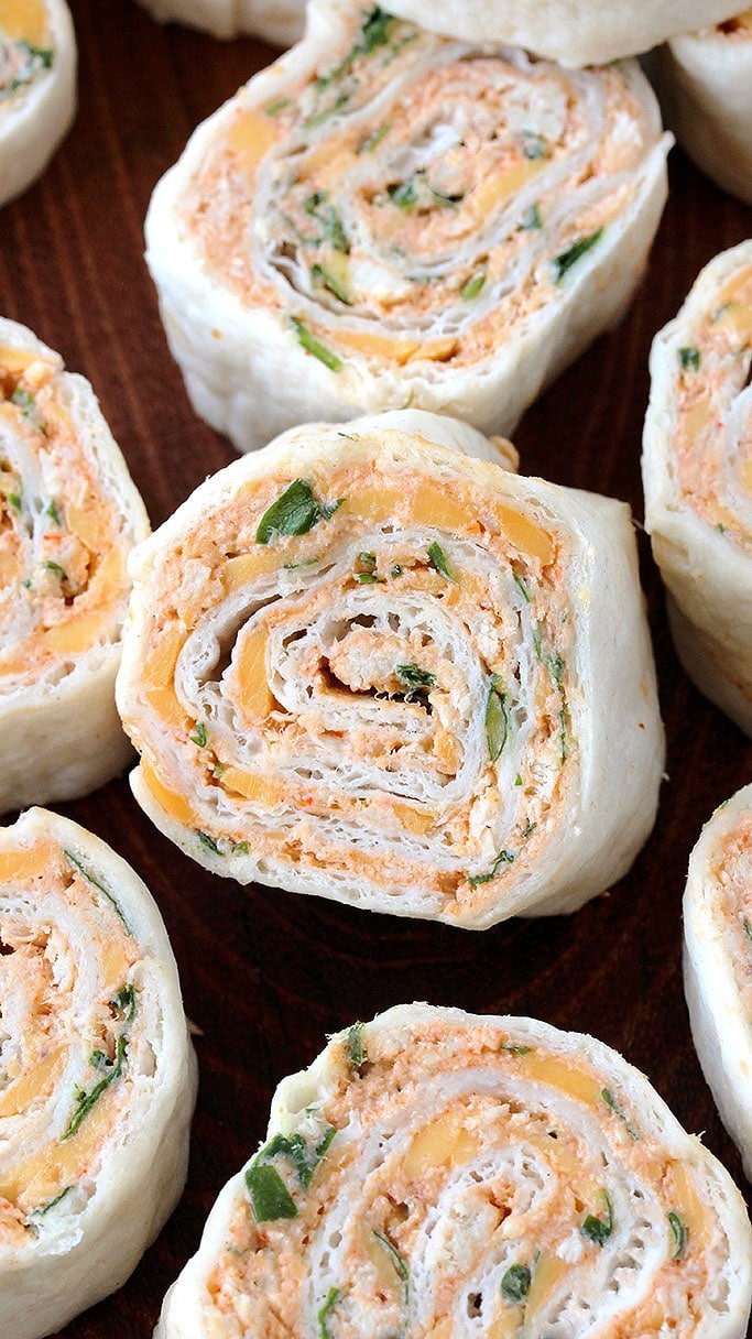 Taco Tortilla Roll Ups this quick and easy party appetizer filled with cream cheese, sour cream, chicken, cheddar cheese, taco seasoning, taco sauce and parsley is perfect for every holiday or a party.