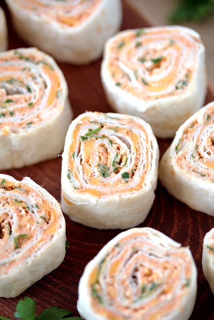 Taco Tortilla Roll Ups – this quick and easy party appetizer filled with cream cheese, sour cream, chicken, cheddar cheese, taco seasoning, taco sauce and parsley is perfect for every holiday or a party