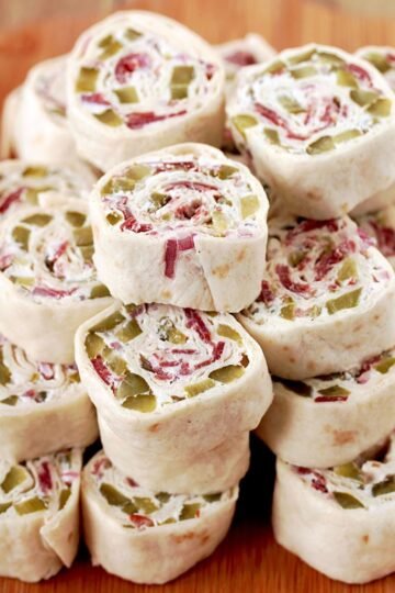 Dill Pickle Tortilla Roll Ups - these party appetizers are filled with cream cheese, sour cream, light mayo, dill pickles, dry beef, onion, ground black pepper and garlic powder, make a perfect choice for Game Day or any other party or holiday
