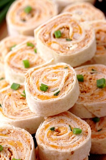 Buffalo Chicken Tortilla Roll Ups – looking for a perfect appetizer that is quick and easy to make? You’re in the right place! These Buffalo Chicken Tortilla Roll Ups are made with cream cheese, cheddar cheese, blue cheese, hot sauce, green onions, chicken, garlic powder and tortillas.