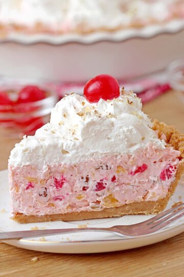 Millionaire pie - this super quick and easy, old fashioned grandma's recipe with rich, tropical taste can be served for potluck, parties or holidays and it'll surely be a hit! This decadent and delicious pie with rich creamy filling made with condensed milk and whipped topping, loaded with pineapple, coconut, pecans and maraschino cherries, on graham cracker crust has a divine taste.