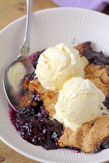 This old fashioned Blueberry Cobbler is the easiest recipe for the tastiest dessert from ingredients you already have on hand, it's simply perfect. Sweet, juicy blueberries coated with crunchy buttery batter are best served warm with a scoop of vanilla ice cream.