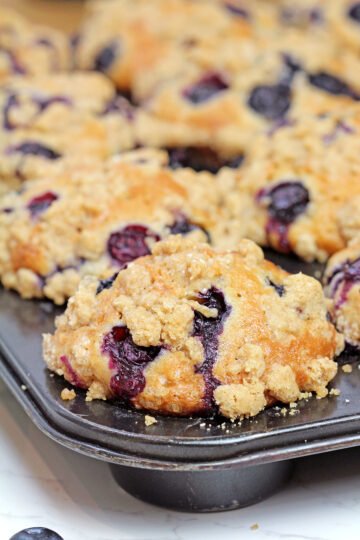 Bake for 25-30 minutes, or until the tops are golden brown and a toothpick inserted into the center comes out clean. Allow the muffins to cool in the pan for about 15 minutes before transferring them to a wire rack.